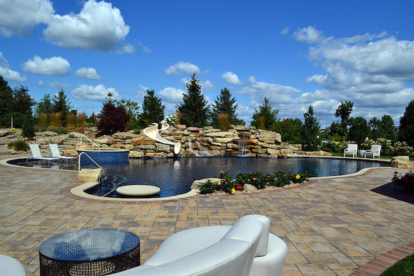 Curving elements, lush plantings, and the relaxing rush of the double waterfall make this design the perfect retreat.