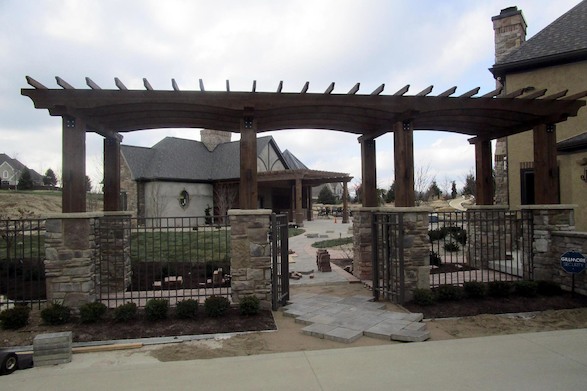 Elegant and purposeful, this stately pergola creates the perfect gateway into the charms of the backyard and visually connects the existing house with the new garage.
