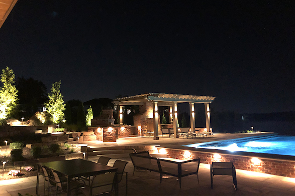Carefully placed LED night lighting creates a warm, inviting nighttime ambiance to the newly expanded swimming pool and outdoor entertaining area.