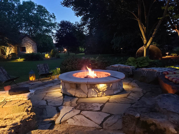 Warm lighting and a cozy fire highlight key features and invite a friendly atmosphere for gathering.