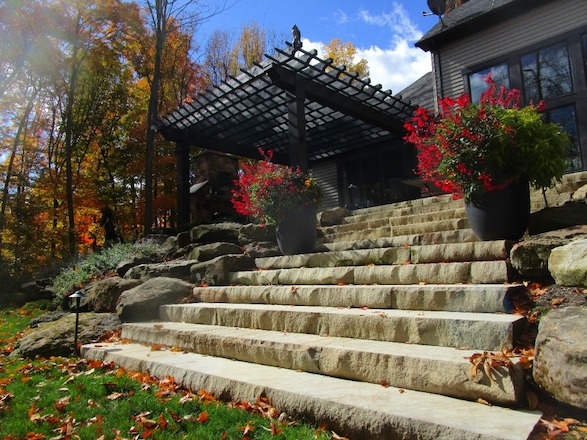 Sandstone steps create not only access to the yard beyond, but a visual focal point to invite visitors into the space.