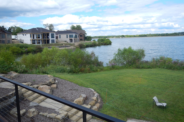 Focus was put on creating a complete outdoor living space while maintaining the tranquil view of the lake and utilizing lush plantings to hide the neighboring construction.