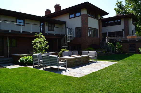 The rectangular shape of the patio, pavers, and firepit reflect the modern, rectangular feel of the rest of the house.