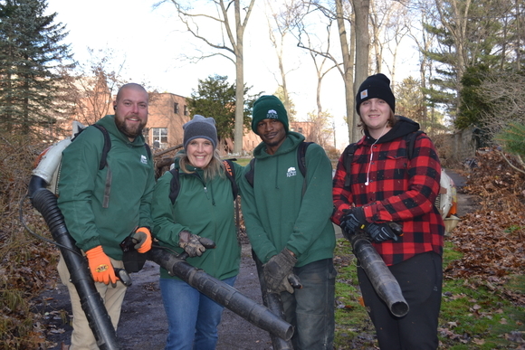 Rice's crew members and community volunteers pose for a photo during Rice's fall clean up at Sancta Clara Monastery