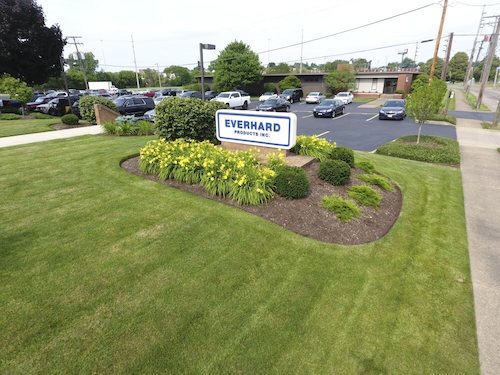 Landscaping around an industrial property’s entrance sign