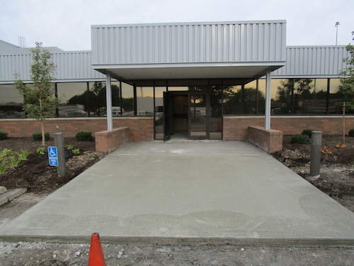 A concrete slab was poured to support the heating element mesh that went under the paver entrance and eliminated ice melt being tracked into the building.