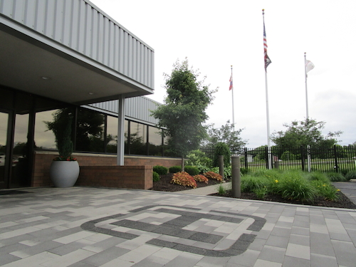 After placing the heating element, we installed pavers that incorporated brand colors and created a paver logo inlay for a striking, functional entrance into the renovated facility.