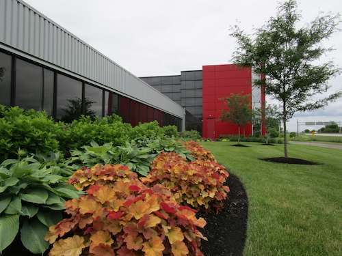 Landscaping at a corporate office — variety of plant sizes and colors in front of Hendrickson