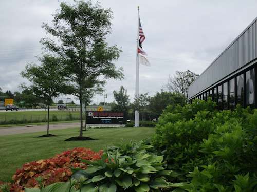 Landscaping at a corporate office — variety of plant sizes and colors near entrance of Hendrickson