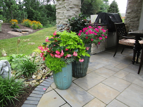 Seasonal landscape colors featured in planters on a patio