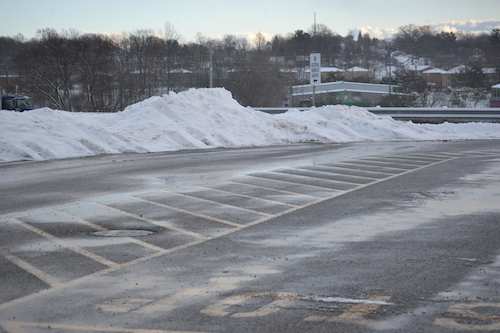 Mounds of snow removed from commercial parking lot