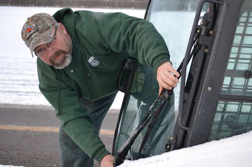 One of Rice's employees working on snow and ice removal for a commercial property